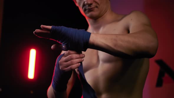 Mma Fighter Man Wrapping His Hands in Boxing Tape Before a Fight Close Up