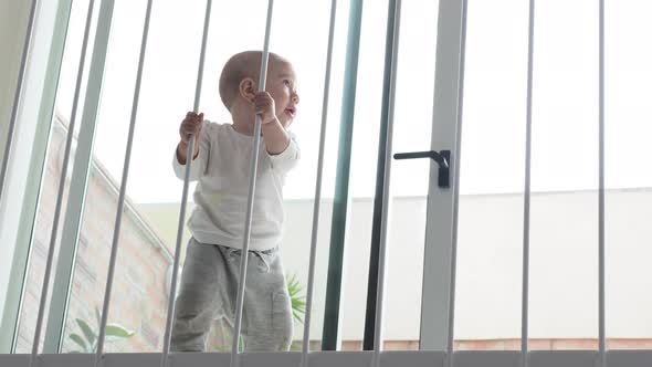 Baby Girl Holding Rails