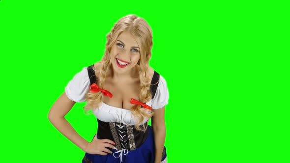 Bavarian Girl in Bavarian Costume Offers a Beer To Someone. Green Screen