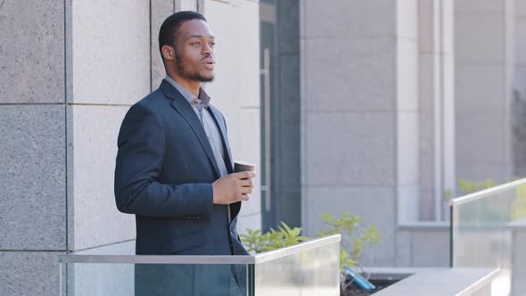 Happy Young African Businessman Student Standing on Balcony Resting at Workplace Finished Work