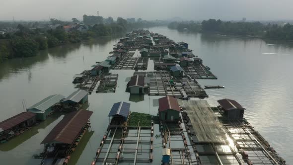 slow drone shot flying over floating fish farming community in Bien Hoa on the Dong Nai river, Vietn