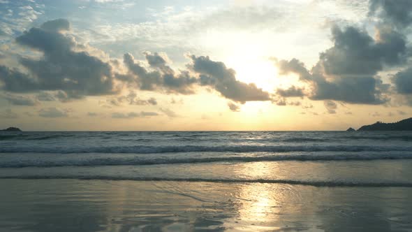 Wave at Phuket beach, Andaman Sea at sunset in Thailand.