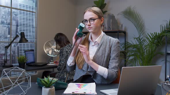 Annoyed Young Businesswoman Talking on Retro Telephone Call Irritated Voice Dissatisfied with Work