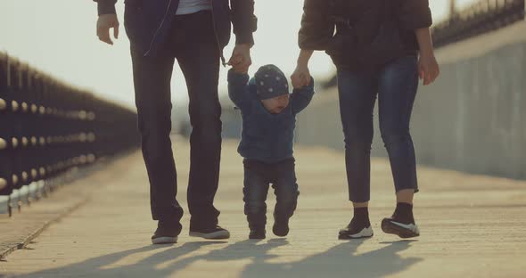 Little Boy Walks with His Parents