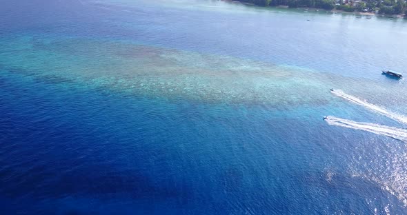 Daytime aerial abstract view of a summer white paradise sand beach and blue water background