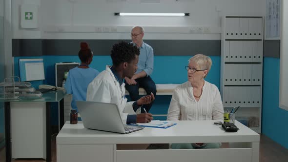 Person with Doctor Profession Writing Medical Information alt