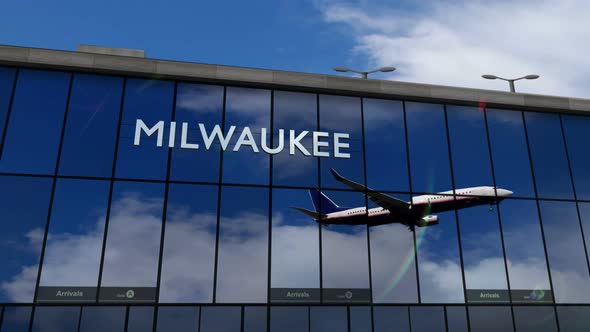 Airplane landing at Milwaukee Wisconsin, USA airport mirrored in terminal alt