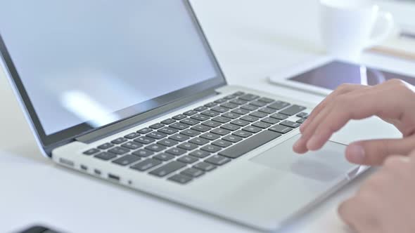 Close Up of Hands Making Report on Laptop