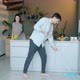 Beautiful Young Couple Doing Cleanup in Kitchen Washing Floor and Furniture - VideoHive Item for Sale