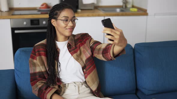 Young Beautiful Smiling Girl with Dreadlocks Taking Selfie Picture with Smart Phone Camera