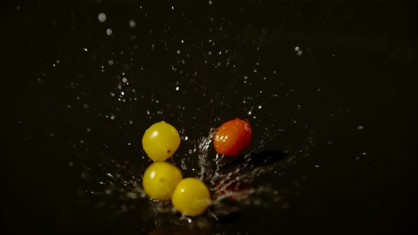Tomatoes falling on a wet surface, Ultra Slow Motion