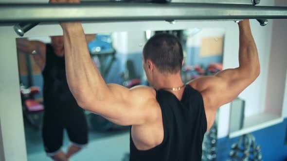 Athlete Doing Pullup on Horizontal Bar in the Gym