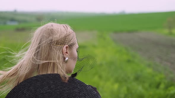 Flamboyant Girl In Black Dress Goes By The Field.