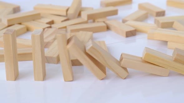 Domino Effect Row of Wooden Domino Falling Down on White Background