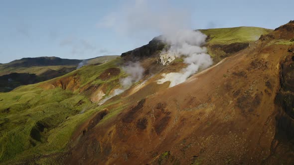 Steam coming out of the hills in Iceland showing geothermal power of Earth
