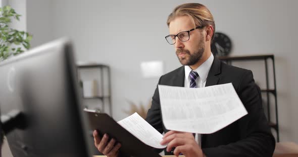 Businessman Reading Documents at Office