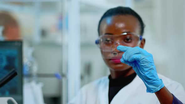 Close Up of African Scientist Looking at Virus Test