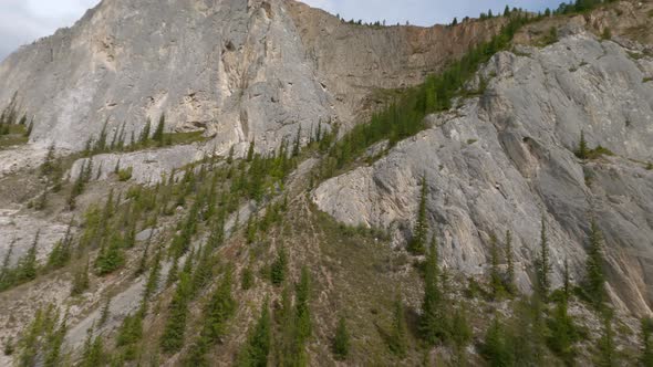 Aerial View Flying Natural Cliff Top of White Marbled Limestone Rising Above River Wild Landscape