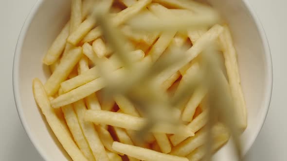 SLOW MOTION: French Fries Falling Into A White Bowl