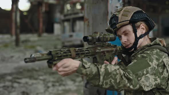 Armed Woman Soldier with Weapon on Destroyed Plant