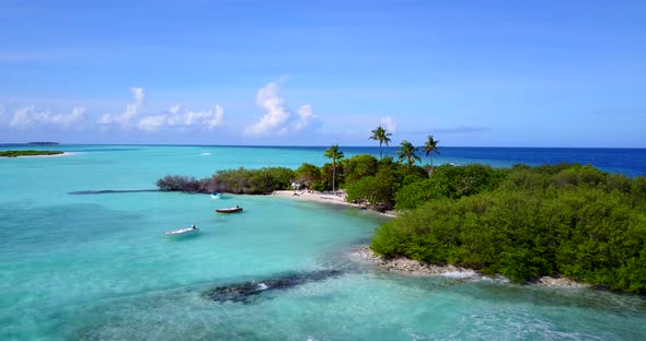 Beautiful birds eye travel shot of a white sandy paradise beach and blue sea background in hi res 4K