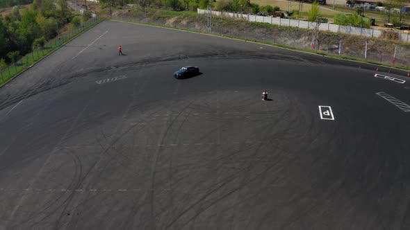 Racing black car at drifting festival near the gas factory