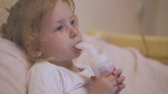 Upset Girl Breathes with Inhaler To Cure Cough in Bed