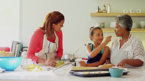 Happy multi-generation family preparing gingerbread in kitchen 4k