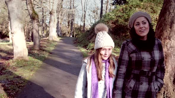 Mother and daughter walk in a public park