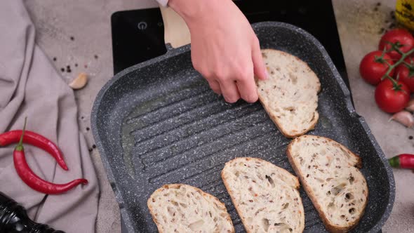 Toasting Slices of Baguette in a Grill Frying Pan