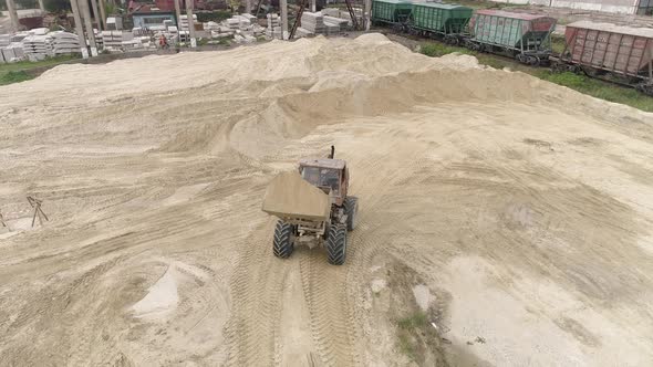 Excavator carrying sand