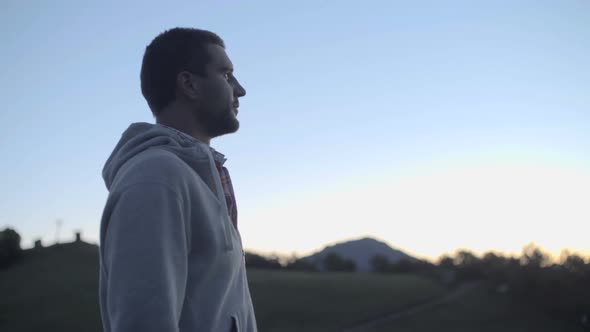 Close Up of Young Man Looking Around Panorama in Nature Mountain Outdoor at Sunrise or Sunset