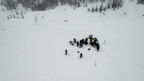 Tourists on a Halt in a Snowy Forest