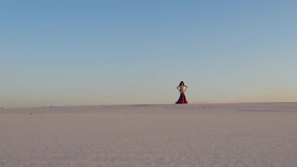 Dancer Against the Sky Dancing Belly Dance in a Brilliant Outfit