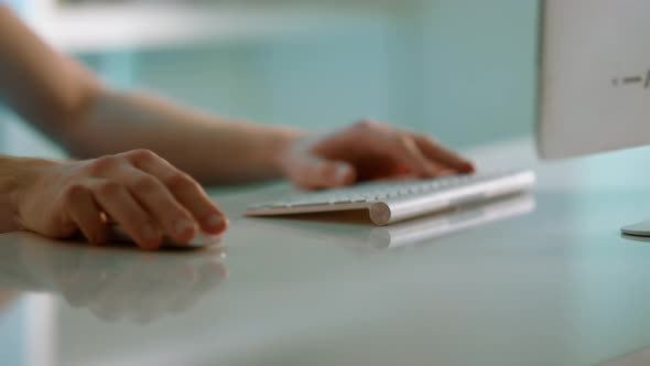 Closeup Hands Scrolling Mouse at Office Desk