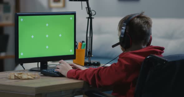 Wheelchaired Boy Using Computer