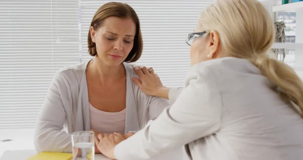 Psychologist reassuring her patient