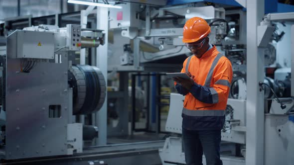 Engineer Use Tablet Computer at Industrial Factory Closeup