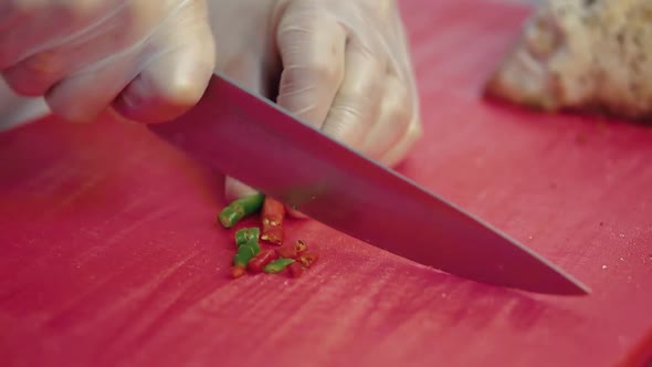 Cook Chops the Chili Pepper for the Salad