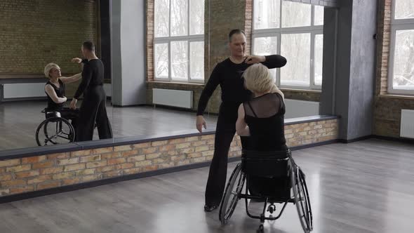 Positive Middle Aged Couple Dancing in Ballroom