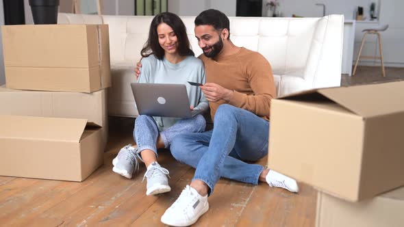 Cheerful Young Indian Couple Move in New Apartment