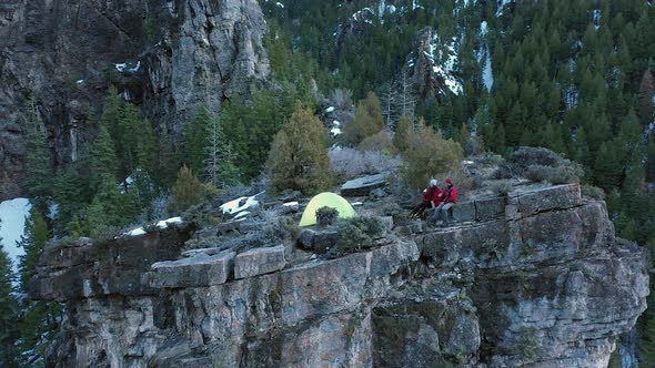 Flying over campsite on the top of a cliff's edge