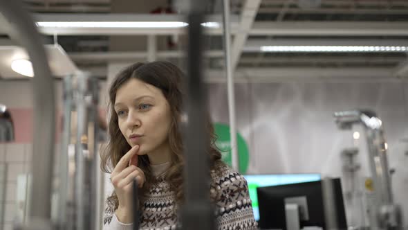 Brunette Woman Chooses New Faucet for Apartment Renovation