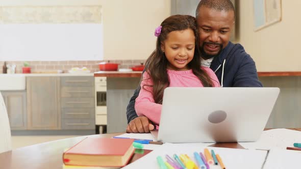 Father and daughter using laptop 4k