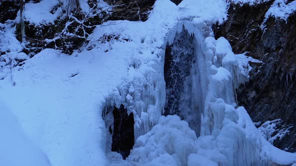 Frozen Winter Waterfall Guk in the Carpathian Mountains in the Forest