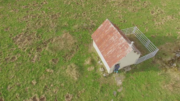 Aerial view of a trail runner and a small house