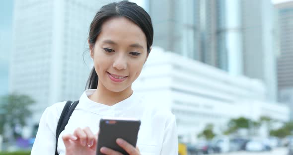 Woman look at mobile phone in city