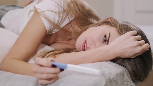 Worried Girl After Looking at Pregnancy Test at Home