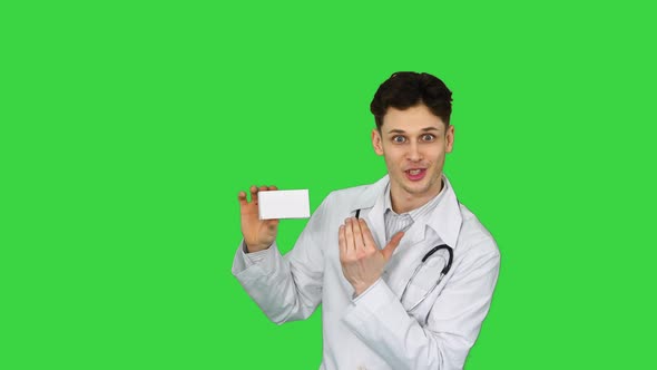 Young Doctor Presenting New Pills and Dancing on a Green Screen, Chroma Key.