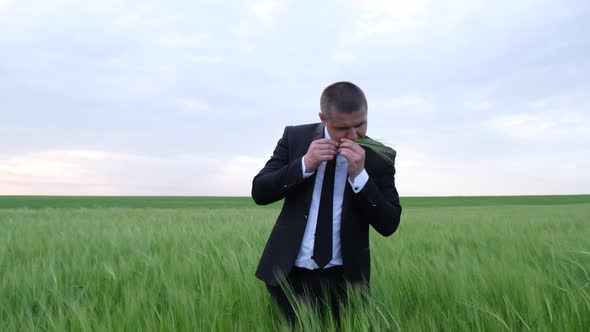 Young Farmer Business Owner Inspects a Wheat Field